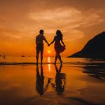 couple-holding-hands-on-the-beach_1296-89