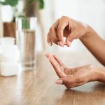 Unrecognizable,African,Woman,Taking,Beauty,Supplements,For,Glowing,Skin,,Holding